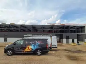 Bestelwagens van Aqua & Fire bij de nieuwbouwhal, project Voorbereidende leidingwerken Pelletketel